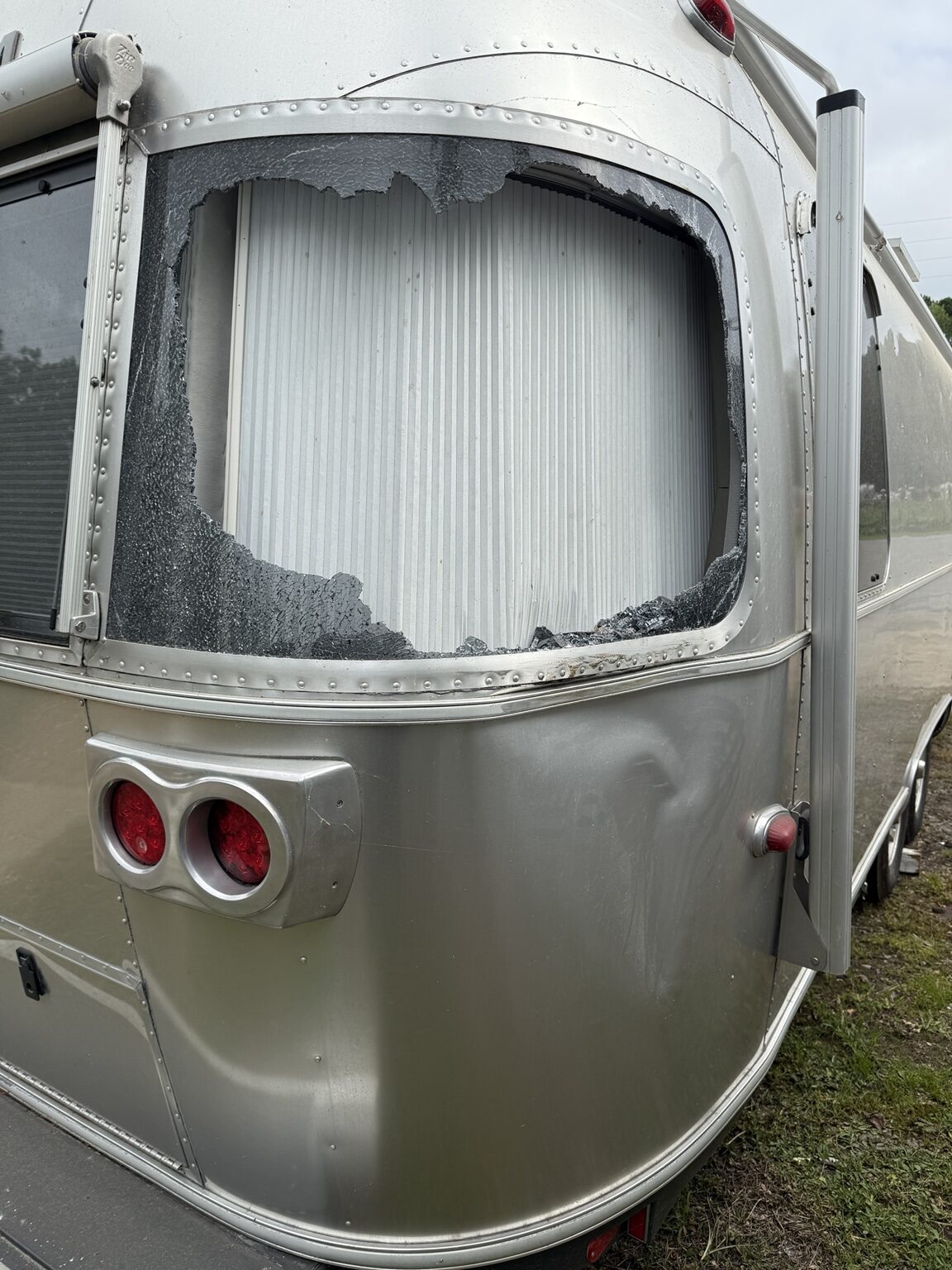 Before repair: shattered curved rear Airstream window